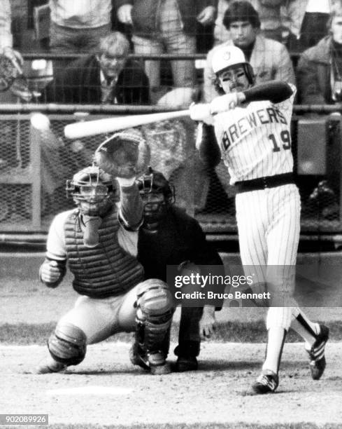 Robin Yount of the Milwaukee Brewers checks his swing for a two-out, two RBI single as catcher Darrell Porter of the St. Louis Cardinals and umpire...