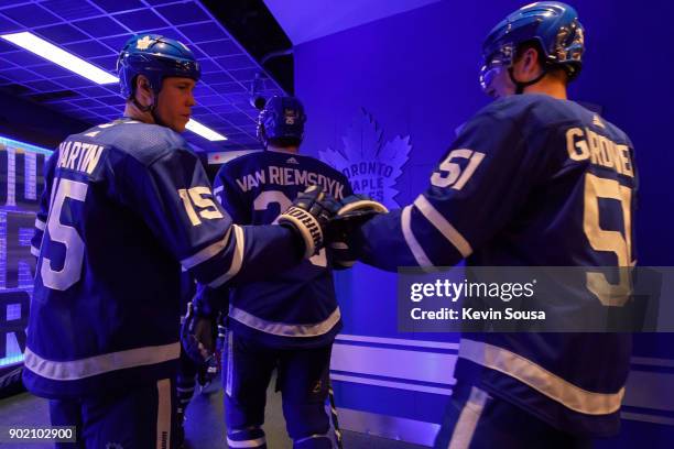 Matt Martin of the Toronto Maple Leafs gives Jake Gardiner a high five prior to the third period against the San Jose Sharks at the Air Canada Centre...