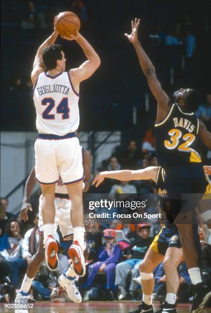 Tom Gugliotta of the Washington Bullets shoots over Dale Davis of the Indiana Pacers during an NBA basketball game circa 1992 at the Capital Centre...