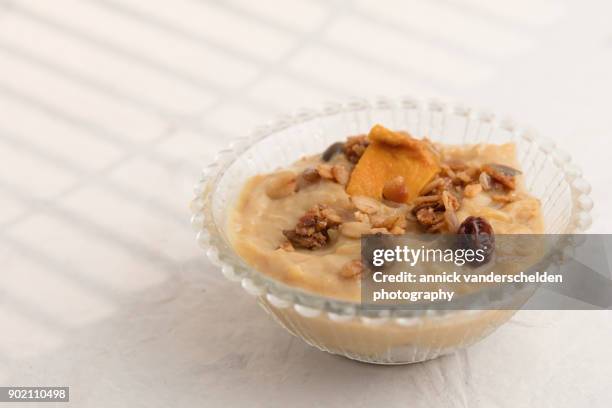 rice pudding dessert with dried mango and cranberry granola garnish. - cornstarch stock pictures, royalty-free photos & images