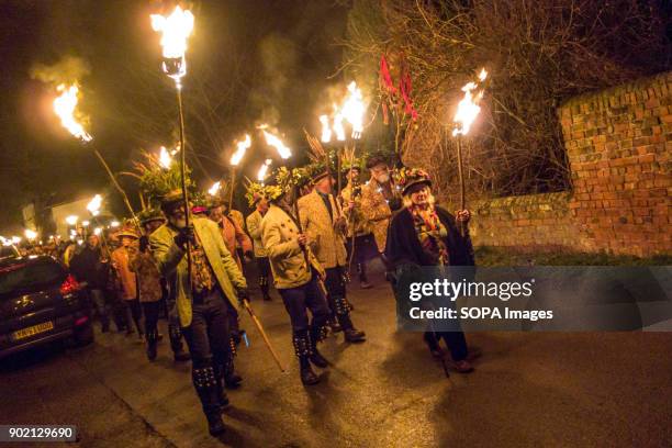 Members of the Leominster Morris seen walking through the street with crowds at the Crown Inn before heading to the apple orchard of Mr Richard...