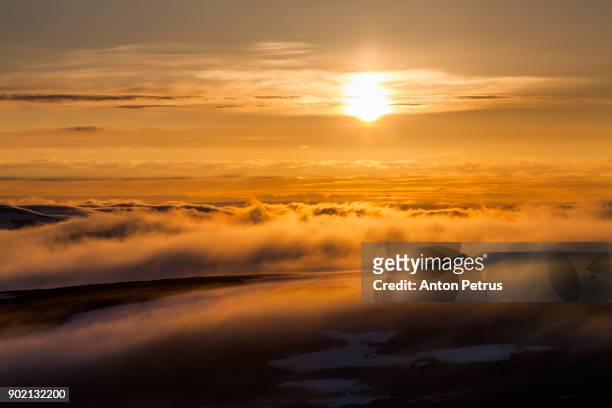 fog in the mountains at sunset. norway, finnmark - mid summer stock pictures, royalty-free photos & images