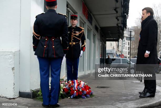 French President Emmanuel Macron and Paris mayor Anne Hidalgo pay their respect during a memorial ceremony outside the Hyper Casher supermarket to...