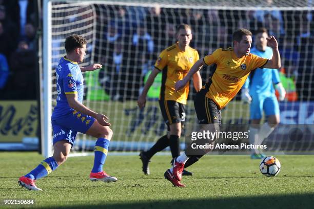 Matt Dolan of Newport County is marked by Kalvin Phillips of Leeds United during the Fly Emirates FA Cup Third Round match between Newport County and...