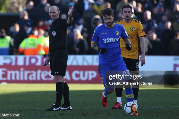 Referee Mike Dean awards a free kick during the Fly Emirates FA Cup Third Round match between Newport County and Leeds United at Rodney Parade on...