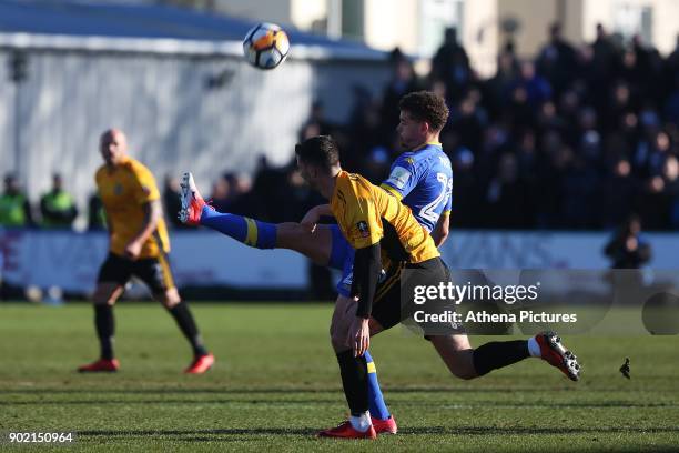 Kalvin Phillips of Leeds United is challenged by Padraig Amond of Newport County during the Fly Emirates FA Cup Third Round match between Newport...