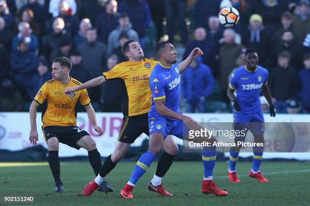 Jay-Roy Grot of Leeds United is challenged by Matt Dolan of Newport County during the Fly Emirates FA Cup Third Round match between Newport County...
