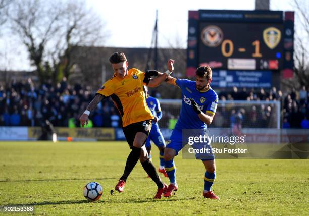 Ben White of Newport County and Mateusz Klich of Leeds United battle for the ball during The Emirates FA Cup Third Round match between Newport County...