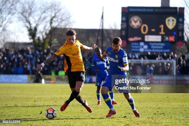 Ben White of Newport County and Mateusz Klich of Leeds United battle for the ball during The Emirates FA Cup Third Round match between Newport County...