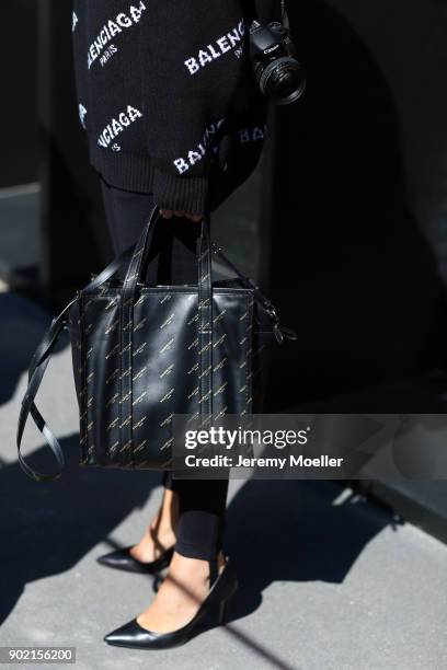 Fashion Week visitor wearing a Balenciaga hoodie and bag during the Milan Fashion Week on September 20, 2017 in Milan .