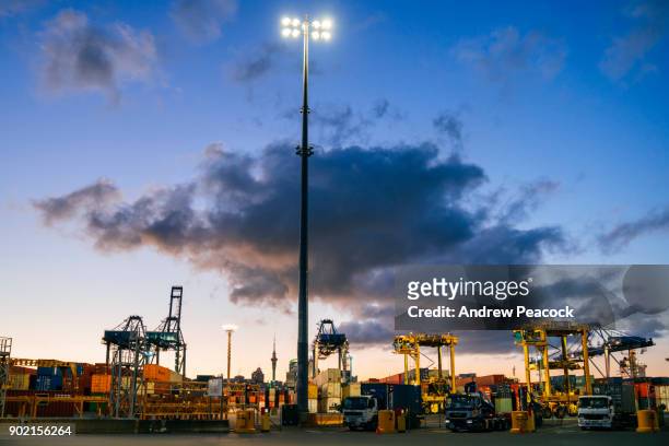 fergusson container terminal and city skyline at sunset - auckland skyline stock pictures, royalty-free photos & images