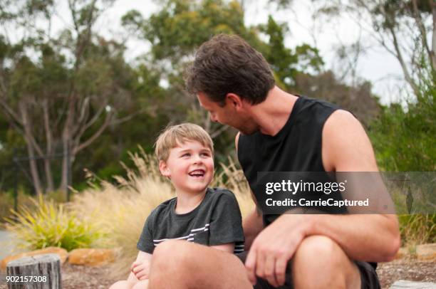 happy father and son sitting together - middle class stock pictures, royalty-free photos & images