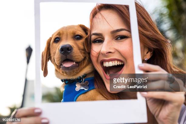 happy woman with his labrador puppy in miami beach. - photography themes stock pictures, royalty-free photos & images