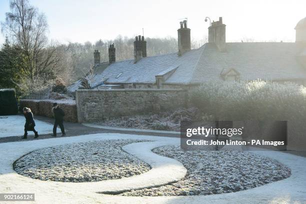 People walking in widespread frost in Glasgow's Pollok Park, as temperatures plummet across the UK.