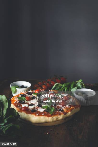 homemade italian pizza on wooden table - mediterranean culture stock pictures, royalty-free photos & images