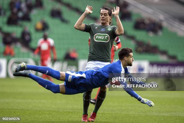 Nimes' French goalkeeper Baptiste Valette vies with Saint-Etienne's French midfielder Romain Hamouma during the French Cup football match,...