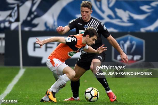 Lorient's French defender Vincent Le Goff vies with Angers' French forward Baptiste Guillaume during the French Cup football match match between...