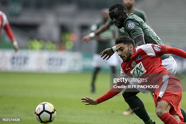 Saint-Etienne's Senegalese defender Cheikh M'Bengue vies with Nimes' French midfielder Romain Del Castillo during the French Cup football match...