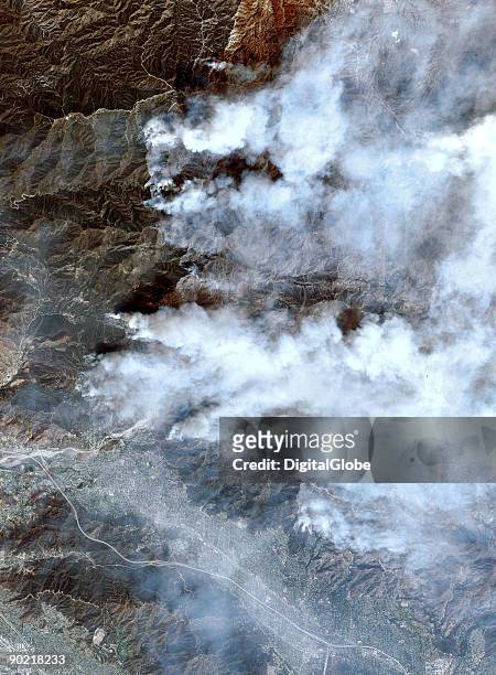 In this satellite image clouds rise to sky as the deadly Station Fire gradually marches west on August 31, 2009 in Los Angeles, California. The...