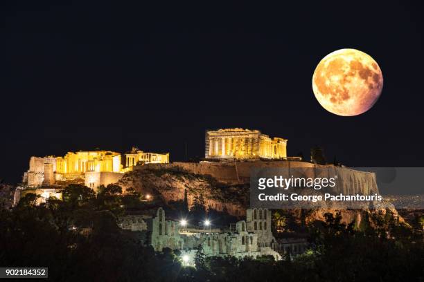 super moon over the acropolis in athens, greece - supermoon fotografías e imágenes de stock