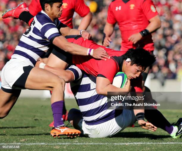 Kosuke Horikoshi of Teikyo dives to score his side's first try during the 54th All Japan University Rugby Championship Final at Teikyo and Meiji at...