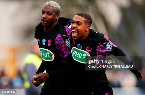 Bordeaux's Senegalese midfielder Younousse Sankhare is congratulated by Bordeaux's forward Malcom after scoring a goal during the French Cup football...