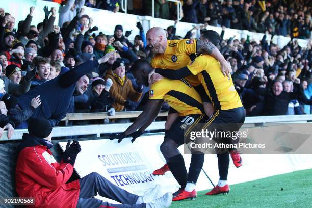 David Pipe and Padraig Amond join Frank Nouble of Newport County as he celebrates scoring his sides first goal of the match to equalise with Leeds...