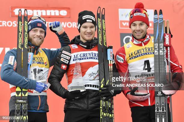 Switzerland's winner Dario Cologna poses on the podium with second-placed Norwey's Martin Johnsrud Sundby and third-placed Canada's Alex Harvey...