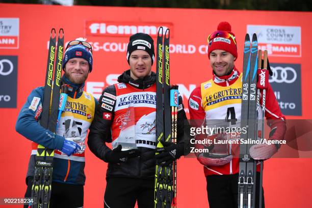 Dario Cologna of Switzerland takes 1st place, Martin Johnsrud Sundby of Norway takes 2nd place, Alex Harvey of Canada takes 3rd place during the FIS...