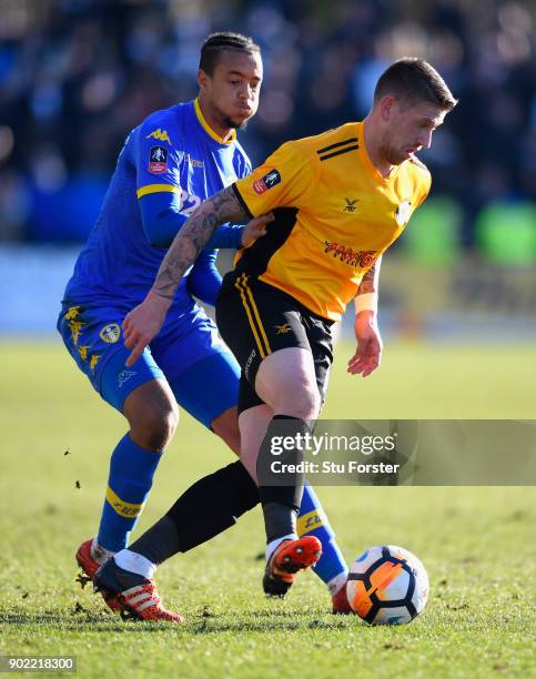 Leeds player Cameron Borthwick- Jackson challenges Scott Bennett of Newport during The Emirates FA Cup Third Round match between Newport County and...