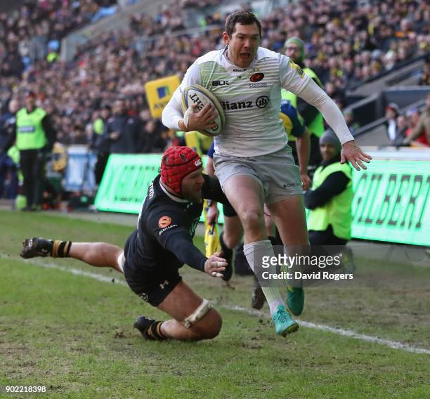 Alex Goode, the Saracens fullback breaks clear of James Haskell to score their second try during the Aviva Premiership match between Wasps and...