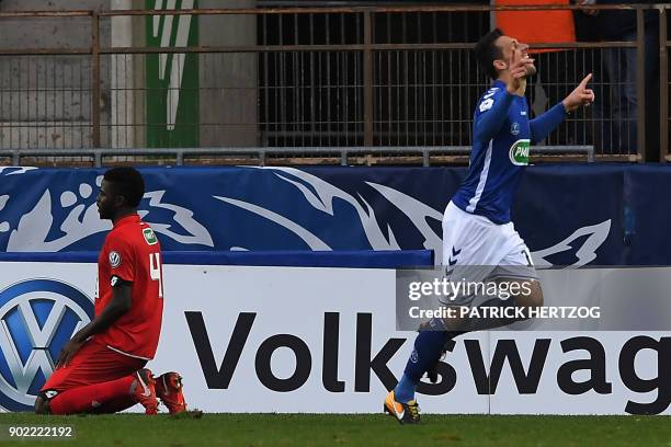 Strasbourg's French forward Jeremy Blayac celebrates after scoring a goal next to Dijon's defender Papy Djilobodji reacting during the French Cup...