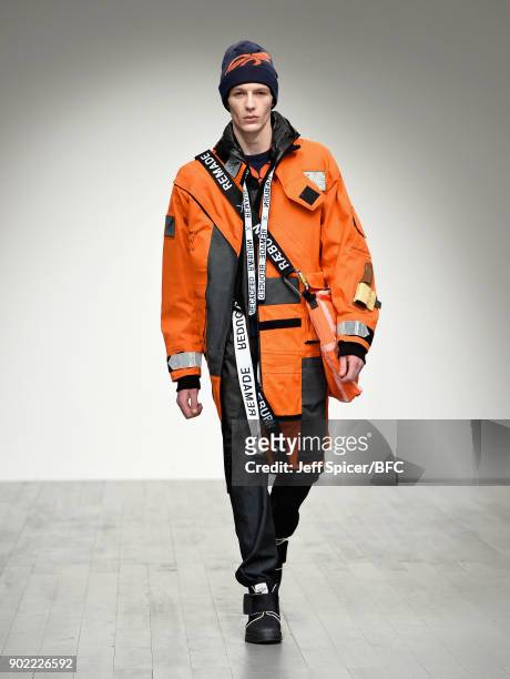 Model walks the runway at the Christopher Raeburn show during London Fashion Week Men's January 2018 at BFC Show Space on January 7, 2018 in London,...