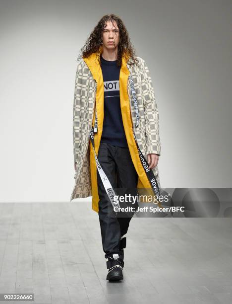 Model walks the runway at the Christopher Raeburn show during London Fashion Week Men's January 2018 at BFC Show Space on January 7, 2018 in London,...
