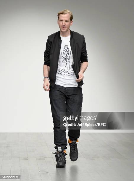 Fashion designer Christopher Raeburn on the runway after his show during London Fashion Week Men's January 2018 at BFC Show Space on January 7, 2018...
