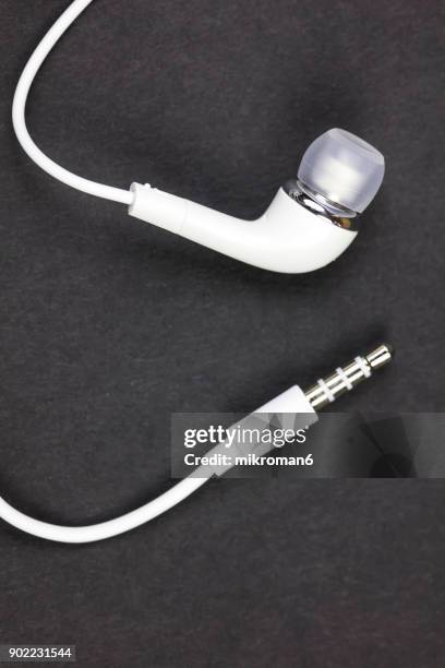 close-up of white earphones on black background - rca stock pictures, royalty-free photos & images