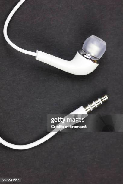 close-up of white earphones on black background - jack stock pictures, royalty-free photos & images