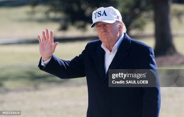 President Donald Trump waves as he walks from Marine One upon arrival on the South Lawn of the White House in Washington, DC, January 7 after...