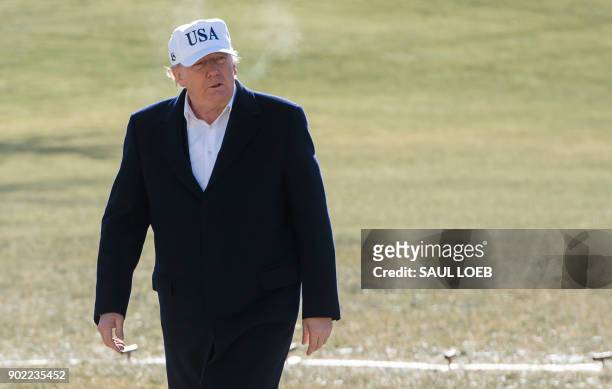 President Donald Trump walks from Marine One upon arrival on the South Lawn of the White House in Washington, DC, January 7 after spending the...