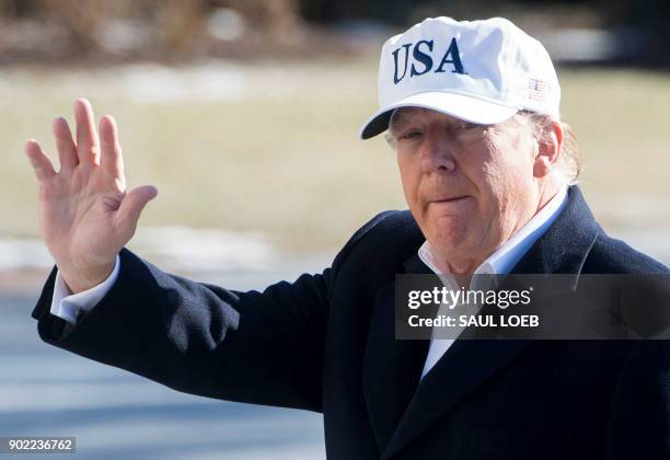 President Donald Trump waves as he walks from Marine One upon arrival on the South Lawn of the White House in Washington, DC, January 7 after...