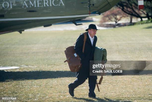 Mick Mulvaney, Director of the Office of Management and Budget, walks from Marine One after arriving with US President Donald Trump on the South Lawn...