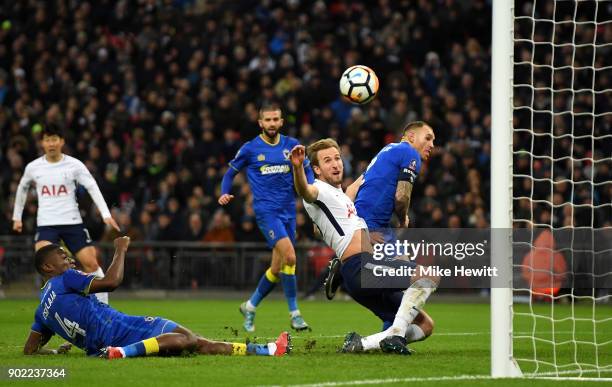 Harry Kane of Tottenham Hotspur scores the opening goal during The Emirates FA Cup Third Round match between Tottenham Hotspur and AFC Wimbledon at...