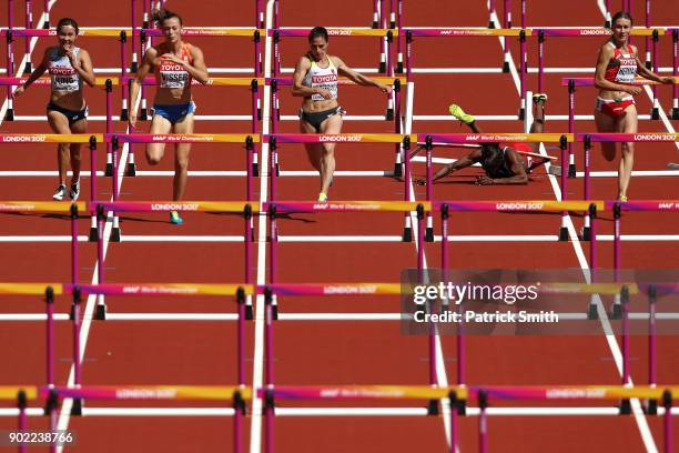 Deborah John of Trinidad and Tobago falls as she competes in the Women's 100 metres hurdles heats during day eight of the 16th IAAF World Athletics...