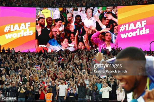 Fans react as Chijindu Ujah, Adam Gemili, Daniel Talbot and Nethaneel Mitchell-Blake of Great Britain celebrate winning gold in the Men's 4x100 Relay...