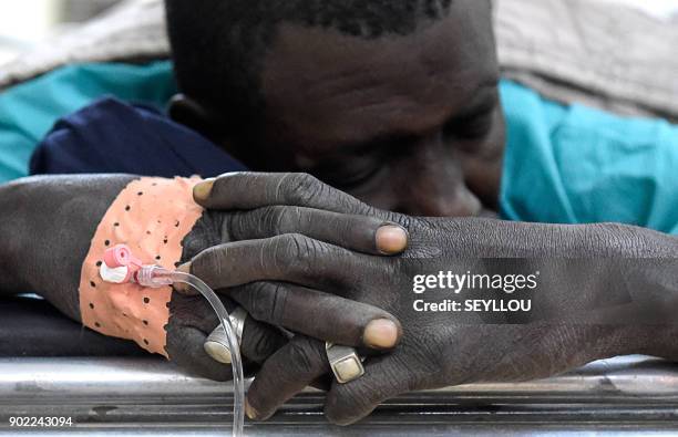 Victim of an attack by armed men in the Bayotte forest lies on a hospital gurney in the regional capital Ziguinchor, southern Senegal on January 7,...