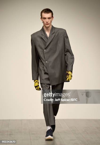 Model walks the runway at the Alex Mullins show during London Fashion Week Men's January 2018 at BFC Show Space on January 7, 2018 in London, England.