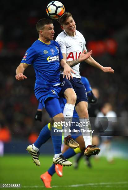 Cody McDonald of AFC Wimbledon and Juan Foyth of Tottenham Hotspur fight for the header during The Emirates FA Cup Third Round match between...