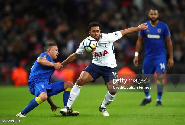 Cody McDonald of AFC Wimbledon and Mousa Dembele of Tottenham Hotspur compete for the ball during The Emirates FA Cup Third Round match between...