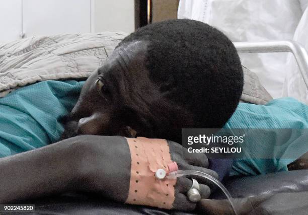 Victim of an attack by armed men in the Bayotte forest lies on a hospital gurney in the regional capital Ziguinchor, southern Senegal on January 7,...