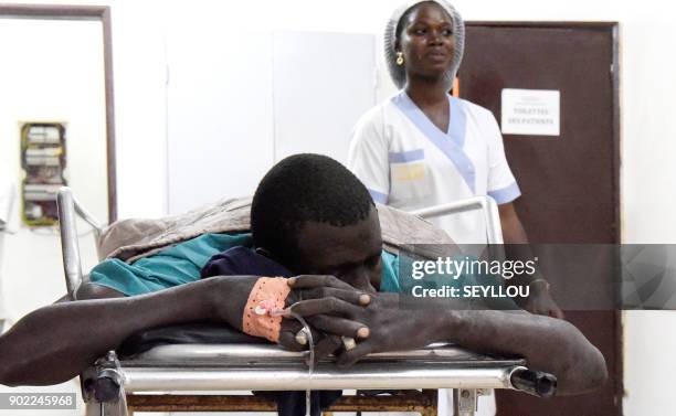 Victim of an attack by armed men in the Bayotte forest lies on a hospital gurney in the regional capital Ziguinchor, southern Senegal on January 7,...